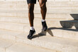 © Artem Podrez/Stocksy - close-up of the legs of a man running up the stairs