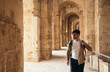© Pedro Merino/Stocksy - Backpacker man visiting El Djem roman amphitheater in Tunisia