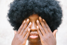 Afro Girl Holding Hand In Front Of Her Face