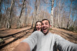 © Ibai Acevedo/Stocksy - Excited couple selfie at the mountain