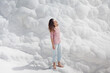© EASY 2 SHOOT/Stocksy - Young pretty woman having fun in snow-white limestone terrain