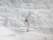 © EASY 2 SHOOT/Stocksy - Young pretty woman having fun in snow-white limestone terrain