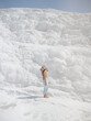 © EASY 2 SHOOT/Stocksy - Young pretty woman having fun in snow-white limestone terrain