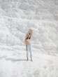 © EASY 2 SHOOT/Stocksy - Young pretty woman having fun in snow-white limestone terrain