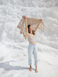 © EASY 2 SHOOT/Stocksy - Young pretty woman having fun in snow-white limestone terrain