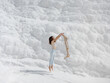 © EASY 2 SHOOT/Stocksy - Young pretty woman having fun in snow-white limestone terrain