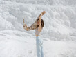 © EASY 2 SHOOT/Stocksy - Young pretty woman having fun in snow-white limestone terrain