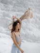 © EASY 2 SHOOT/Stocksy - Young pretty woman having fun in snow-white limestone terrain