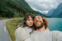 Selfie Of Man And Woman On The Background Of Blue Lake In Mountains