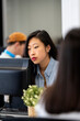 © Santi Nuñez/Stocksy - Focused asian woman Working In A Modern Office