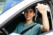 © BONNINSTUDIO/Stocksy - Smiling teen boy showing car keys in car