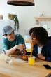 © BONNINSTUDIO/Stocksy - Casual friends eating delicious food at home