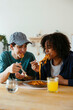 © BONNINSTUDIO/Stocksy - Casual friends eating delicious food at home