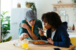 © BONNINSTUDIO/Stocksy - Casual friends eating delicious food at home