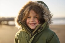 Portrait Of A Cute Little Girl In Winter Jacket At Seaside