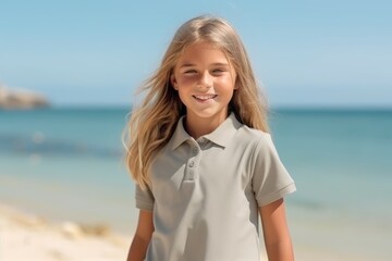 Portrait of a cute little girl smiling at camera on the beach