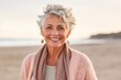 © Eber Braun - Portrait of smiling senior woman standing on the beach at the day time