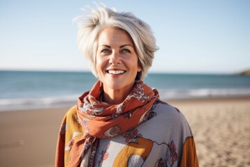 Portrait of smiling woman wearing scarf on the beach at the day time