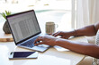 © Trinette Reed/Stocksy - Closeup of Black woman looking at financial spreadsheet on computer