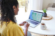 © Trinette Reed/Stocksy - Black woman looking at online map while planning