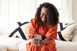 © Trinette Reed/Stocksy - Portrait of happy mature Black woman texting on phone