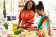 © Trinette Reed/Stocksy - Mature Black girlfriends making healthy summer drinks together