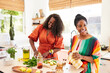 © Trinette Reed/Stocksy - Black girlfriends cooking healthy meal together in the kitchen at home