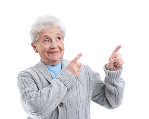 Poster - Senior woman pointing at something on white background