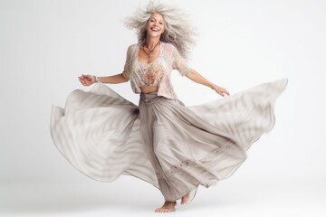 Full length portrait of a happy mature woman dancing isolated on a white background