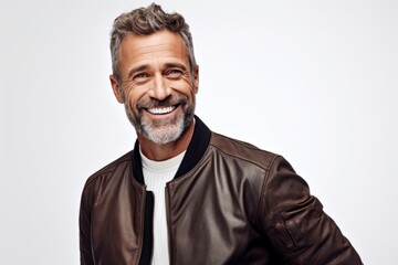 Handsome middle aged man smiling and looking at camera over white background