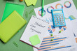 © Pixel-Shot - Notepad with text STUDENT LOAN FORGIVENESS, calculator, charts and stationery on green background