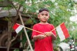 happy indonesian kids with flag at outdoor