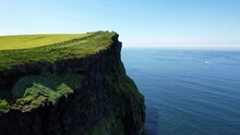 Backward Drone View Steep Cliffs Of Moher With Mossy Edges On Sunny Day. Closeup