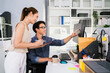 © artitwpd - Cheerful young group of Asian businessmen in casual with one sitting and pointing at the computer display and colleagues discussing around him during the meeting. Diversity of businessmen in a meeting