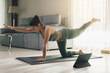 © ADDICTIVE STOCK - Flexible woman in Bird Dog pose on mat at home