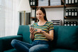 © Nuttapong punna - Caucasian woman using the smartphone and tablet on the sofa at home. Embrace Digital Lifestyle'...Caucasian woman using the smartphone and tablet on the sofa at home. Embrace Digital Lifestyle'