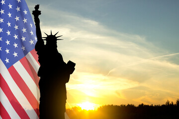 Silhouette of Statue of Liberty against the sunset. Background for Independence Day or National Holidays