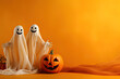 canvas print picture - Halloween ghosts with funny pumpkin on orange background. Happy halloween holiday concept.