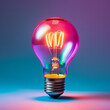 © Aisyaqilumar - A bright light bulb floating on a coloured background. Incandescent and glowing light bulb.