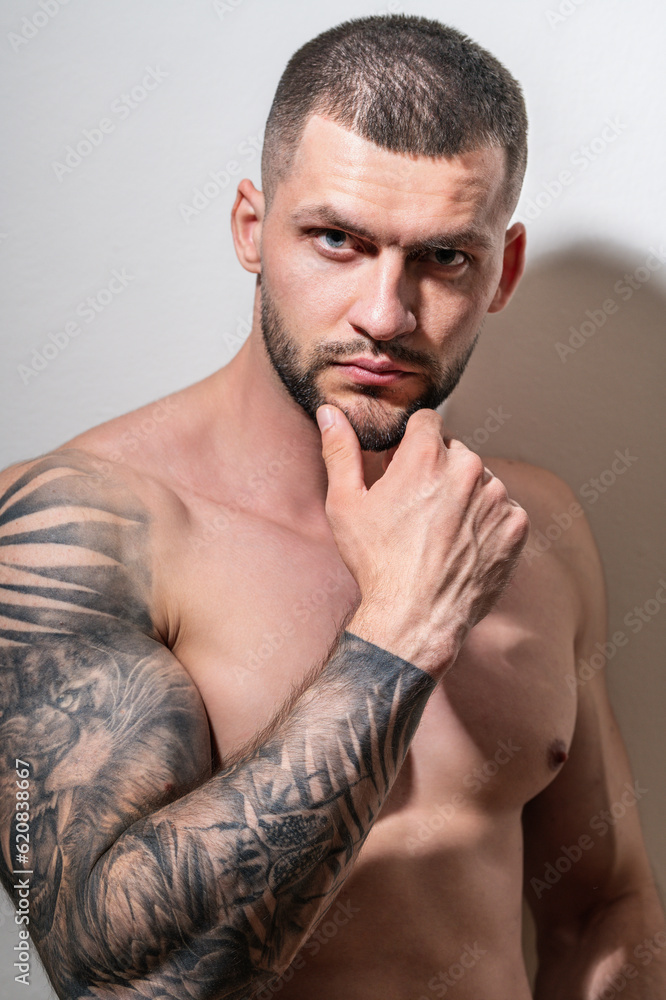 Sexy and naked muscular young man sensual posing. Sexy shirtless male