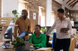 © Wavebreak Media - Happy african american colleagues using computer and talking in creative office