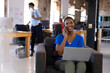© Wavebreak Media - Happy african american colleagues using computer and talking on smartphone in creative office