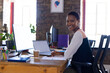 © Wavebreak Media - Portrait of happy african american casual businesswoman using laptop in office