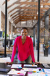 © Wavebreak Media - Portrait of happy african american casual businesswoman with documents on table in office