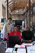 © Wavebreak Media - Portrait of happy african american colleagues with documents on table using laptop in office