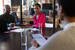 © Wavebreak Media - African american colleagues with documents and graphs on table discussing work in office