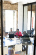 © Wavebreak Media - African american colleagues with documents and graphs on table using laptop in office