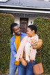 © Wavebreak Media - Happy african american young couple looking at each other and standing outside new house with keys