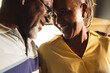 © Wavebreak Media - Happy senior african american couple embracing and talking at home