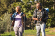© Wavebreak Media - Senior african american couple with backpacks walking in sunny nature